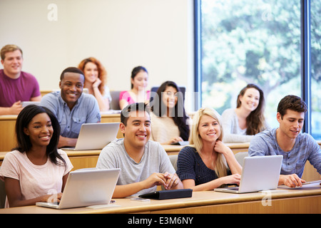 Students Using Laptops And Digital Tablets In Lecture Stock Photo