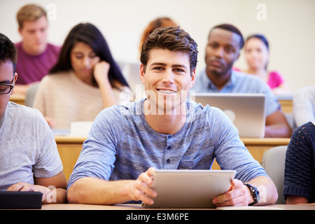 Male University Student Using Digital Tablet In Lecture Stock Photo