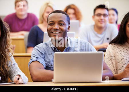 Male University Student Using Laptop In Lecture Stock Photo