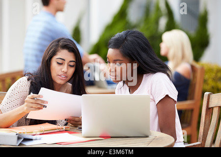 Two University Students Working On Project Outdoors Together Stock Photo