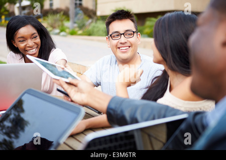 Group Of University Students Working On Project Outdoors Stock Photo