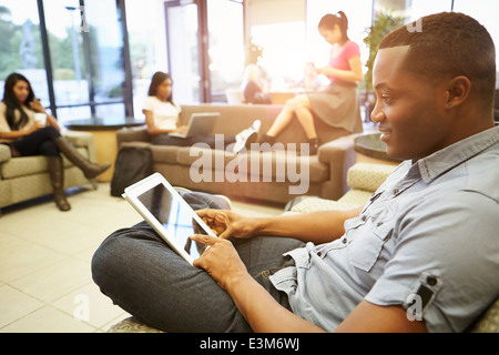 Group Of University Students Relaxing In Common Room Stock Photo