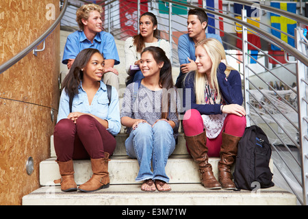 Group Of High School Students Sitting Outside Building Stock Photo