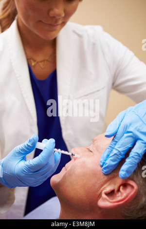 Man Having Botox Treatment At Beauty Clinic Stock Photo