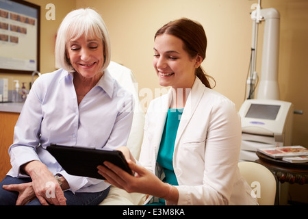 Cosmetic Surgeon Discussing Proceedure With Client In Office Stock Photo