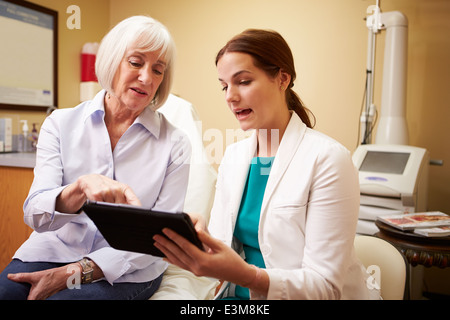 Cosmetic Surgeon Discussing Proceedure With Client In Office Stock Photo