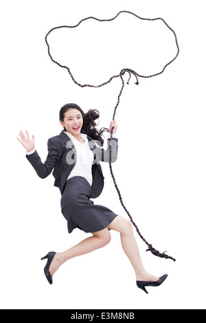 Businesswoman holding rope bubble Stock Photo