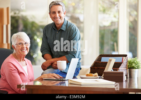 Adult Son Helping Mother With Laptop Stock Photo