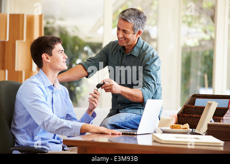 Father Giving Teenage Son Car Keys Stock Photo