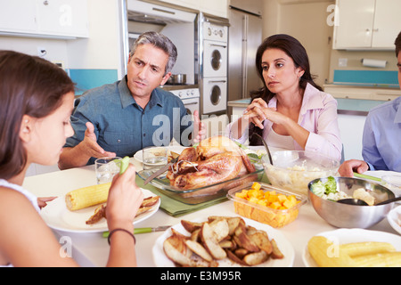 Family Having Argument Sitting Around Table Eating Meal Stock Photo