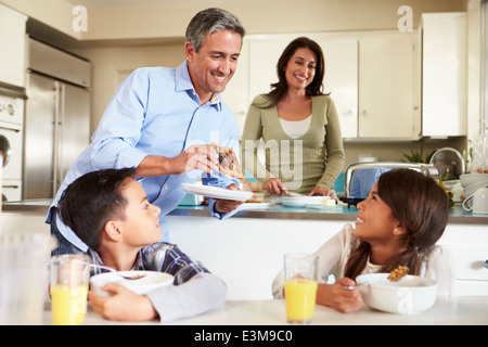 Hispanic Family Eating Breakfast At Home Together Stock Photo