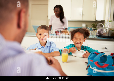 Family Eating Breakfast At Home Together Stock Photo