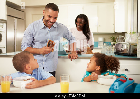 Family Eating Breakfast At Home Together Stock Photo