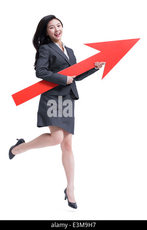 Businesswoman with red arrow sign Stock Photo - Alamy
