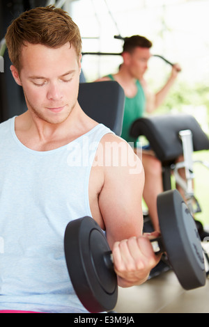 Two Young Men Training In Gym With Weights Stock Photo