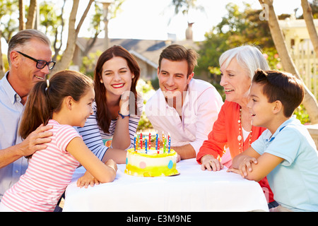 Multi-Generation Family Celebrating Birthday In Garden Stock Photo