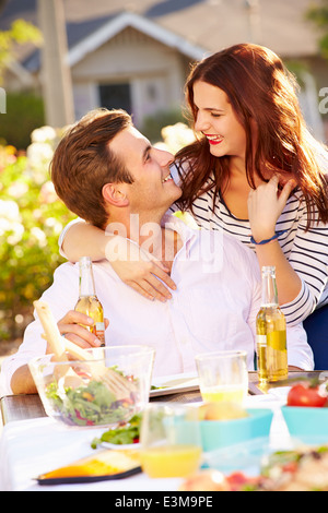 Romantic Couple Enjoying Outdoor Meal In Garden Stock Photo