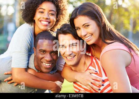 Outdoor Portrait Of Young Friends Having Fun In Park Stock Photo