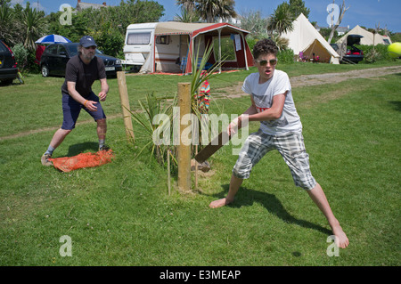 Teenage boy playing cricket, Henry's Campsite, Cornwall, England, UK Stock Photo