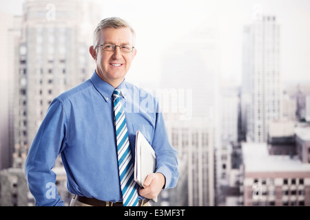 Portrait of smiling businessman in urban window Stock Photo