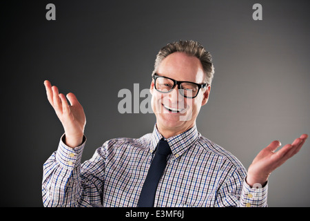 Portrait of happy businessman gesturing Stock Photo