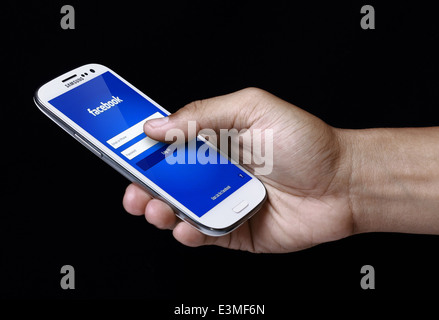 Facebook log in page displayed on smartphone screen. Facebook is a largest social networking website in the world Stock Photo