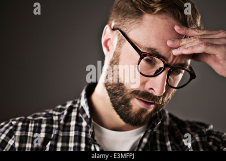 Stressed man with head in hands Stock Photo