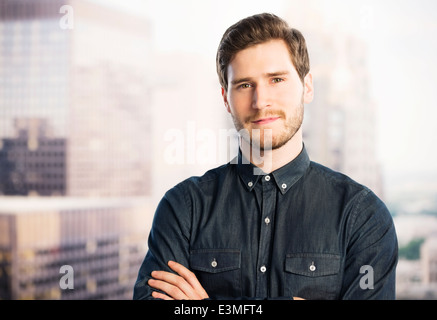 Portrait of confident businessman in urban window Stock Photo