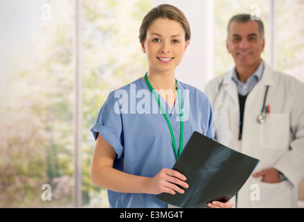 Portrait of smiling nurse with x-ray Stock Photo