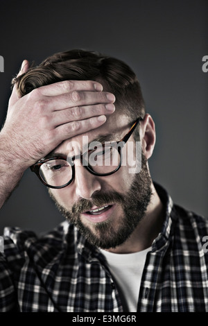 Worried man with head in hands Stock Photo