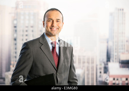 Portrait of confident businessman in urban window Stock Photo