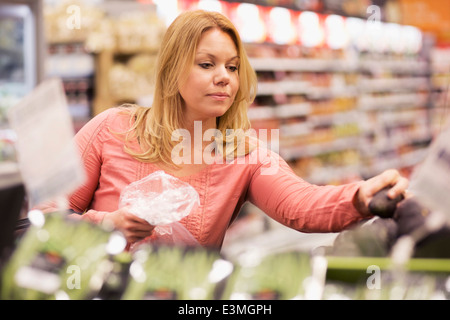 Woman buying groceries in supermarket Stock Photo