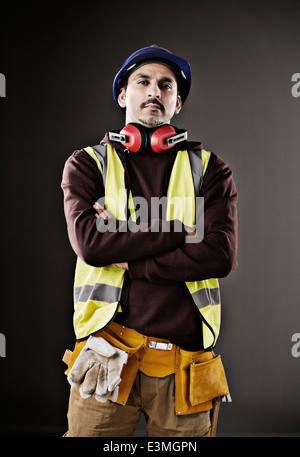 Portrait of serious worker in reflective clothing Stock Photo
