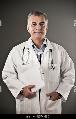 Portrait of confident doctor with clipboard Stock Photo
