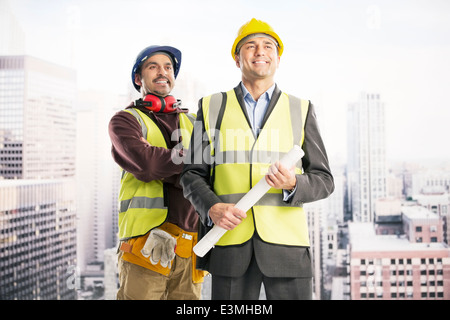 Construction workers in urban window Stock Photo