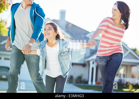 Happy family holding hands and running Stock Photo