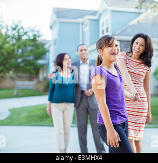 Multi-generation family walking outside house Stock Photo