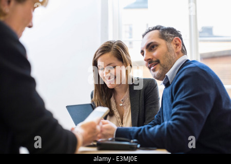 Businesspeople in meeting at office desk Stock Photo