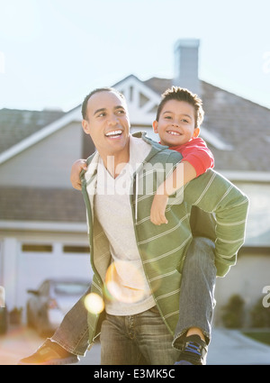 Father piggybacking son Stock Photo