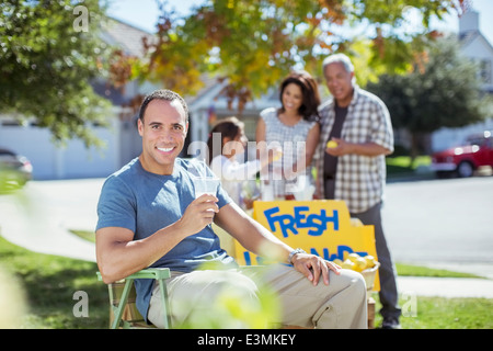 Portrait of smiling man drinking lemonade at lemonade stand Stock Photo