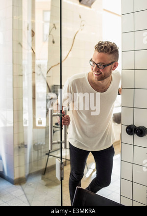 Happy young businessman entering in new office Stock Photo