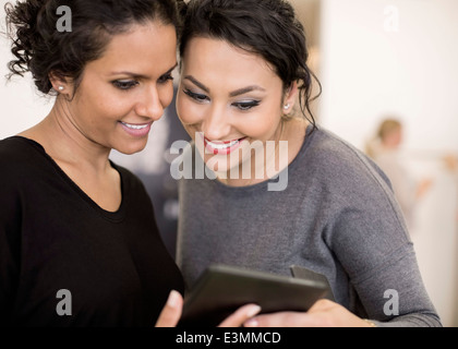 Smiling businesswomen using digital tablet in office Stock Photo