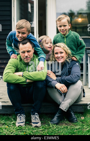 Portrait of happy family on porch Stock Photo