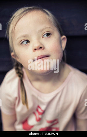 Thoughtful girl with down syndrome looking away Stock Photo