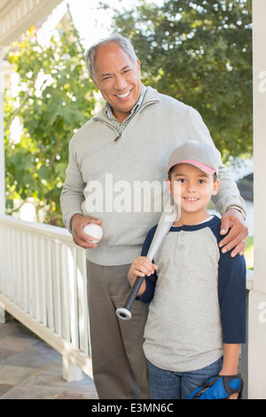 Portrait of grandfather and grandson with baseball and bat Stock Photo