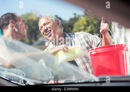 Father and son washing car Stock Photo