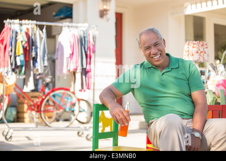 Portrait of smiling man at yard sale