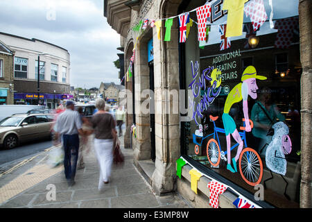 Skipton, Yorkshire Dales National Park, UK. 25th June, 2014. Bikes, Bunting and Window Art as Yorkshire prepares for Le Tour de France by decorating the route with yellow Bikes and Banners as Businesses gear up for the world's greatest cycle race - the Tour de France - which will start in the county on 5th & 6th July 2014 bringing millions of fans to the Yorkshire roadside to cheer on the champions of the sport.  It will be the first time Le Tour has visited the north of England having previously only made visits to the south coast and the capital. Credit:  Mar Photographics/Alamy Live News Stock Photo