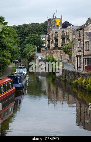 Skipton, Yorkshire Dales National Park, UK. 25th June, 2014. Yellow jersey attached to church as Yorkshire prepares for Le Tour de France by decorating the route with yellow Bikes and Banners as Businesses gear up for the world's greatest cycle race - the Tour de France - which will start in the county on 5th & 6th July 2014 bringing millions of fans to the Yorkshire roadside to cheer on the champions of the sport.  It will be the first time Le Tour has visited the north of England having previously only made visits to the south coast and the capital. Credit:  Mar Photographics/Alamy Live News Stock Photo