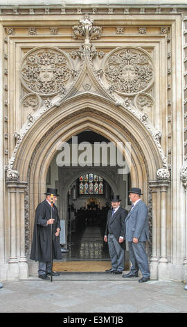 Cambridge, UK. 25th June 2014. The guardians outside the university church (Great St Mary's) where students from Trinity College (Cambridge, England)  wait their turn to go into Senate House for their graduation ceremony on 25 june 2014. Credit:  miscellany/Alamy Live News Stock Photo